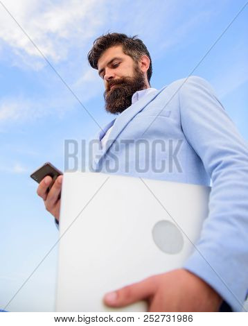 Top Qualities Of Excellent Manager. Man Well Groomed Bearded Hipster Holds Laptop Blue Sky Backgroun