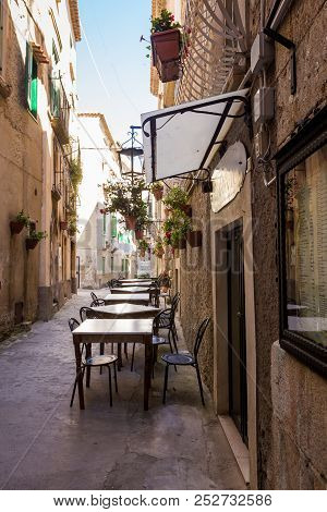 Tropea, Italy - June, 2018: Streets Of Town With Cafes And Restaurants, Motorcycle, Buildings With B