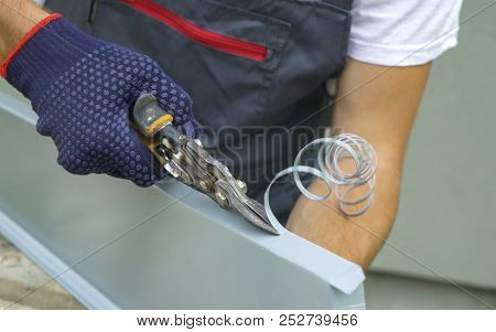 Worker Hands In Protective Gloves Preparing Pvc Window Sill For Installation Cutting Metal With Scis