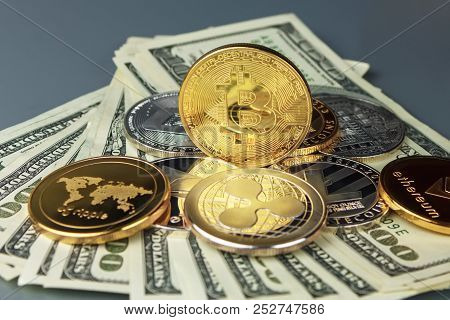 Coins Of Different Crypto-currencies With Dollars. Bitcoin, Dash, Ripple, Ethereum Litecoin