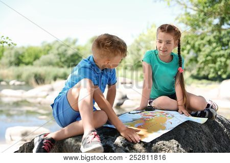 Little Children With Map Outdoors. Summer Camp