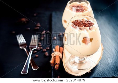 Traditional Italian Dessert Tiramisu In A Glass On Dark Background