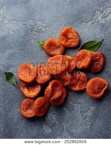 Dried Apricots On Gray Background With Copy Space. Top View.
