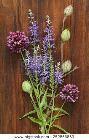 A Beautiful Summer Bouquet, Wildflowers, Wild Onions, Veronica Long-leaved Violet On A Wooden Backgr