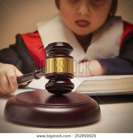 Portrait Of Serious Child Girl Judge (lawyer) Makes A Decision. Humorous Photo.(letter Of Law, Stric