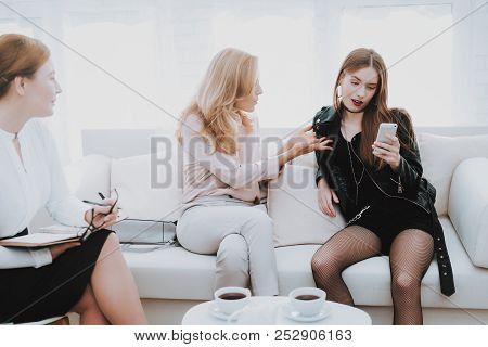 Teenage Girl In Leather Jacket With Upset Mother Taking Selfie In Psychologist Office. Punk In Lathe