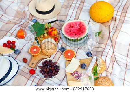 Summer Picnic Basket On The Green Grass. Food And Drink Concept. Friends Party Time