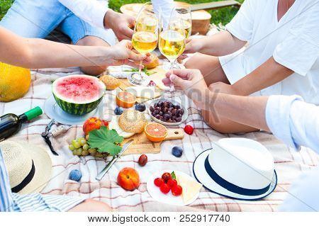 Summer Picnic Basket On The Green Grass. Food And Drink Concept. Friends Party Time