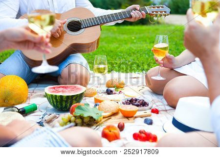 Summer Picnic Basket On The Green Grass. Food And Drink Concept. Friends Party Time