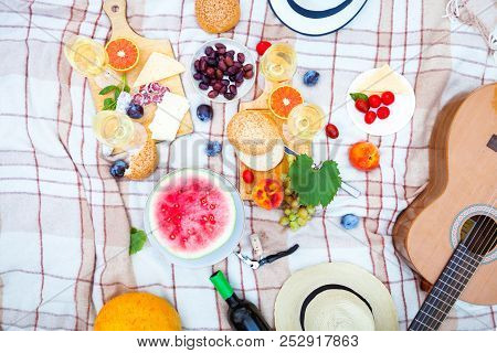 Summer Picnic Basket On The Green Grass. Food And Drink Concept. Friends Party Time