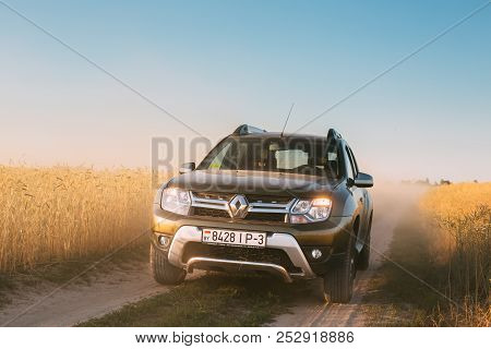 Renault Duster Or Dacia Duster Suv In Country Road Through Summer