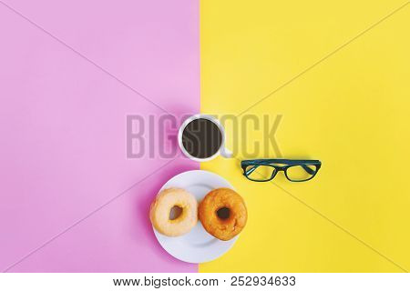 Coffee Time Relax Concept, Black Coffee With Donuts And Eyeglasses On Yellow Pink Pastel Background 