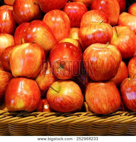 Crop Of Apples. Many Typical Ripe Apples In A Plastic Box.