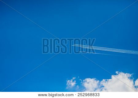 Group Four Aircraft Performing Aerobatics White Cloud