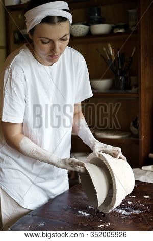 Female Hands Hold A Bowl For Casting Clay Products.
