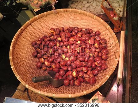 Woven Basket With Roasted Chestnuts For Sale In Japanee Market