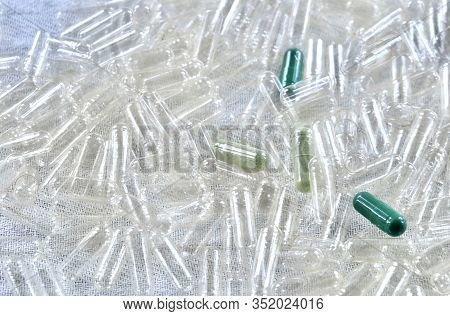 Medical Concept, Green Herbal Medicine On Pile Of Empty Capsules, Use Of Medicinal Plants.
