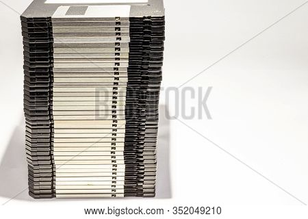 Numerous Black Floppydisks Lined Up On A White Background
