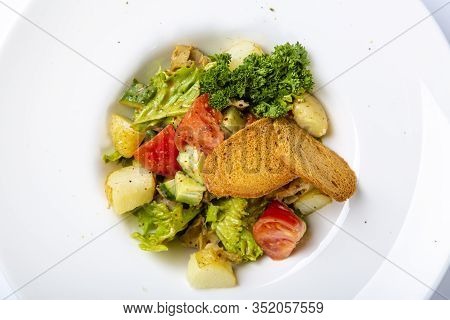 Salad With Black Sea Rapan Meat, Dressed With Honey Sauce. With Rye Crackers. On A Gray Canvas Cloth