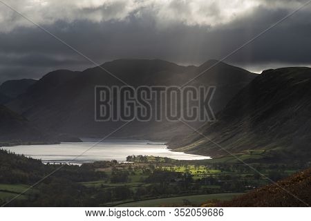 Epic Sun Beams Light Up Crummock Water In Dramatic Autumn Fall Landscape Image With Mellbreak And Gr
