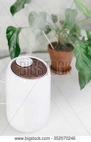 White Air Humidifier Spreading Steam. Humidification Of Dry Air. Selective Focus On Vapor. On Backgr