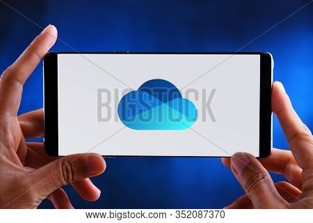 Poznan, Pol - Feb 19, 2020: Hands Holding Smartphone Displaying Logo Of Microsoft Onedrive, A File H