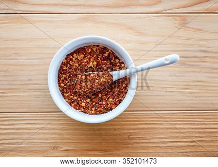 Spicy And Hot Crushed Dried Chili Peppers - Tucana Ljuta Paprika, In White Bowl A Wooden Table Backg