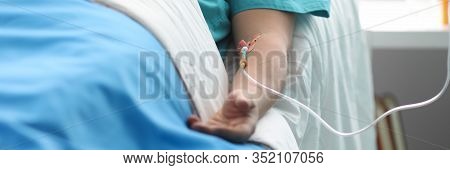 Fight For Life Concept. Hand Of A Young Man With A Dropper In Ward Of Medical Hospital. Lies After C