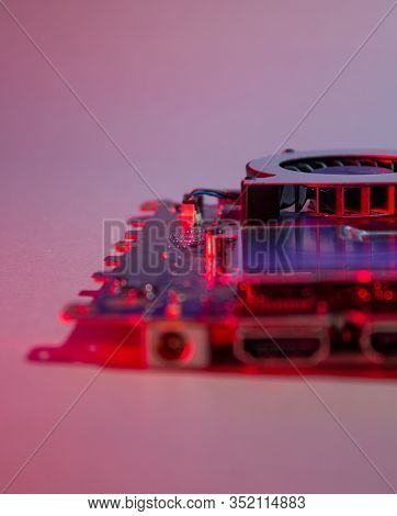 Notebook Motherboard Wrapped In Red Light, Close Up