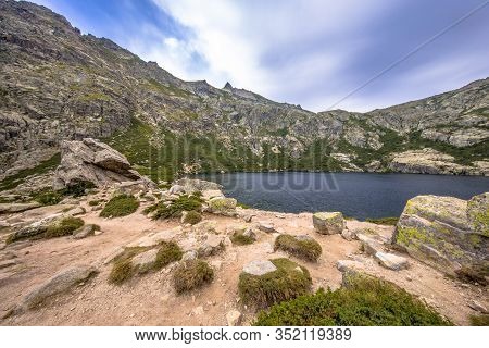 View Over Lake Melo In The Dramatic Lush Restonica Gorge Near Corte On The Island Of Corsica, France