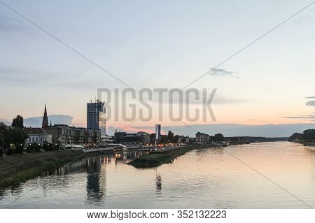 Panorama And Skyline Of Osijek From Drava River With Skyscrapers & The Cathedral Of The City. Osijek