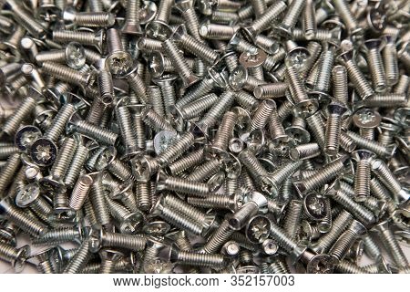 M6 Metal Screws Galvanized White In Bulk Closeup In The Studio