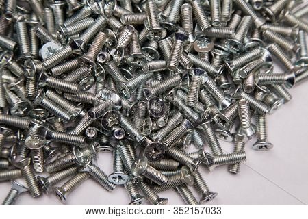 M6 Metal Screws Galvanized White In Bulk Closeup In The Studio