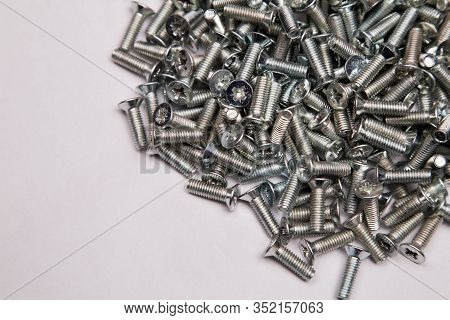 M6 Metal Screws Galvanized White In Bulk Closeup In The Studio