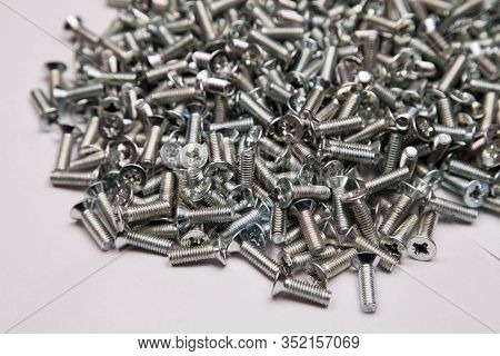 M6 Metal Screws Galvanized White In Bulk Closeup In The Studio