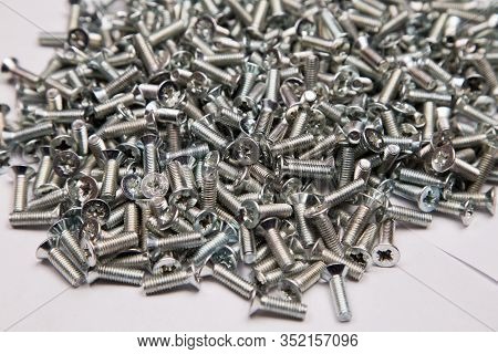 M6 Metal Screws Galvanized White In Bulk Closeup In The Studio