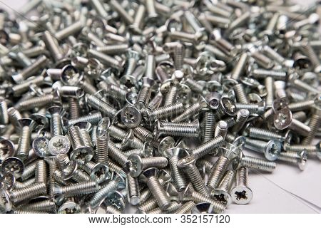 M6 Metal Screws Galvanized White In Bulk Closeup In The Studio