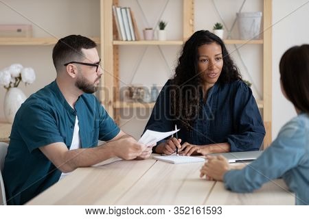 Focused Young African American Female Supervisor Holding Meeting With Teammates.