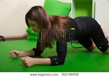 A Young Woman Doing Fitness Exercises In An Ems Suit. Concept: Health, Ems Training, Fitness In Ems 