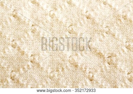 Background Texture Of Rhombus Of White Pattern Knitted Fabric Made Of Cotton Or Wool Closeup