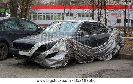 A Broken Car After An Accident In A Parking Lot Covered With A Slid Cover, Iskrovsky Prospekt, Saint