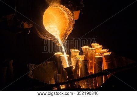 Industrial Lost Wax Casting. The Process Of Pouring For Filling Out Ceramic Shells With Molten Steel