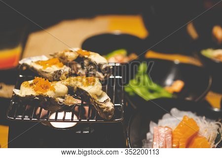 Delicious Japanese Food Grilled Oysters With Cheese And Egg Shrimp Served On Grill