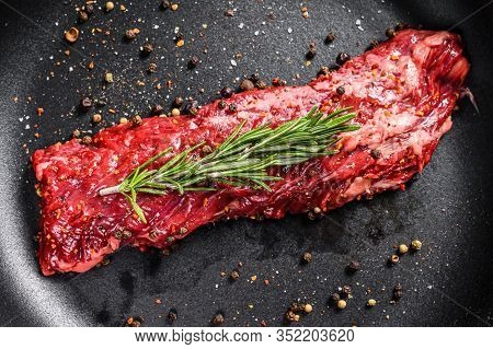 Raw Skirt, Machete Steak In A Pan With Cooking Ingredients. Gray Background. Top View