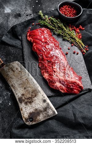 Raw Skirt, Machete Steak With Pink Pepper And Thyme. Black Background. Top View
