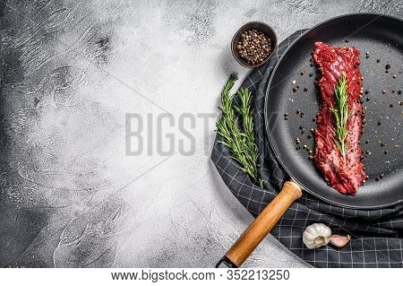 Raw Skirt, Machete Steak In A Pan With Cooking Ingredients. Gray Background. Top View. Copy Space