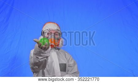 Doctor In Respirator Show A Virus Model. Slow Motion. Woman Wearing Protect Medical Aerosol Spray Pa
