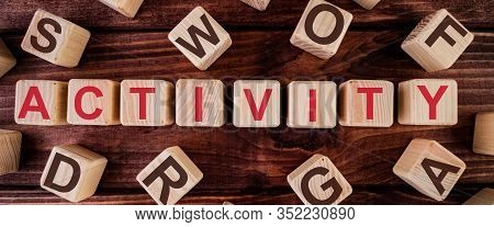 Activity Word On Wooden Cubes On A Dark Wood Background