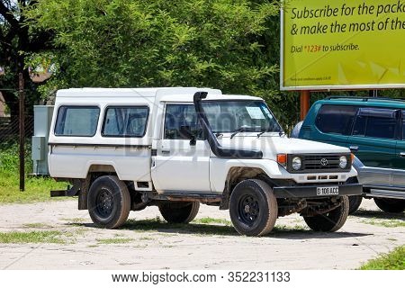 Maun, Botswana - February 9, 2020: White Pickup Truck Toyota Land Cruiser 70 In The Town Street.