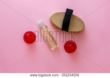 Spa Organic Brush For Dry Massage And A Bottle Of Body Oil On Pink Background. Cactus Brush And Jar 